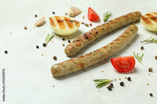 Grilled sausage and spices on white background