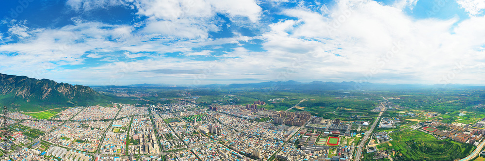 Under the blue sky and white clouds, dense residential areas in Henan, China, wide-angle lens