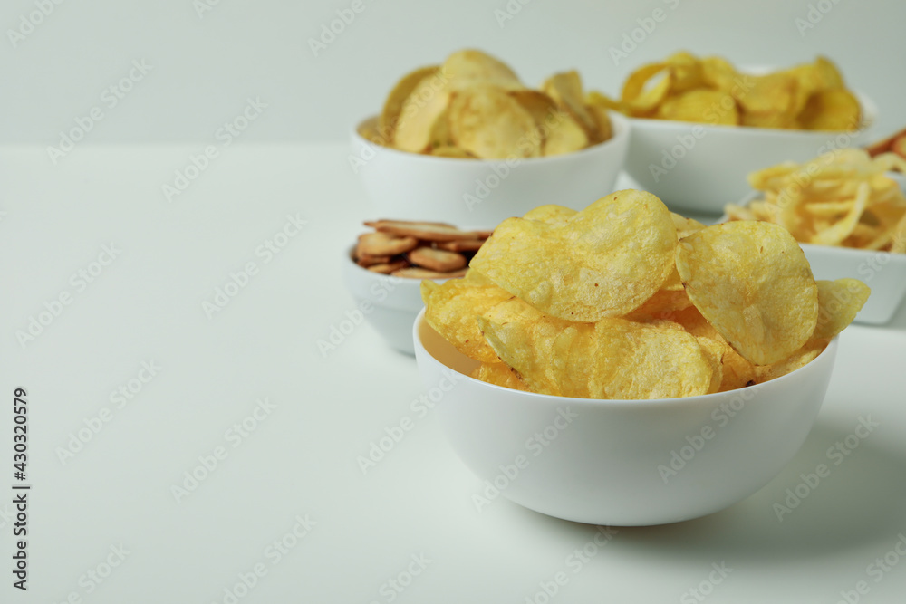 Bowls with different snacks on white background Bowls with different snacks on white background