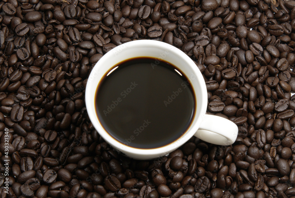 A cup of coffee, coffee beans background, top view A cup of coffee, coffee beans background, top view