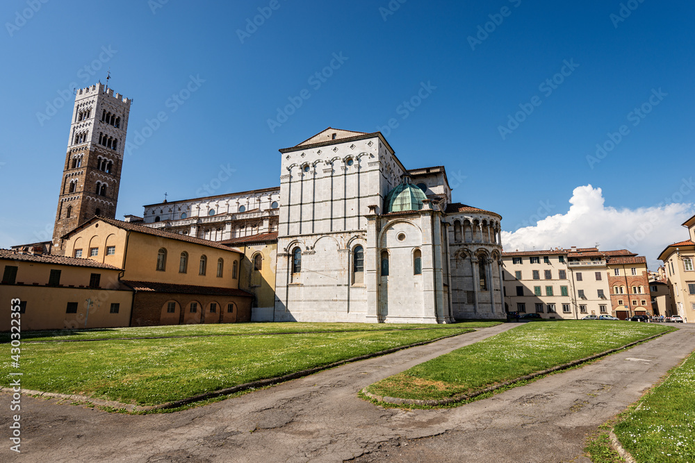 Side view of the Medieval Cathedral of San Martino (Saint Martin), in Romanesque Gothic style, XI - XII century. Piazza San Martino, Tuscany, Italy, Europe.