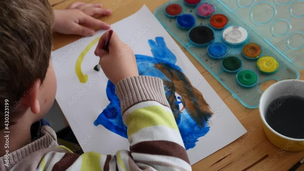 3 years old boy doing painting at home