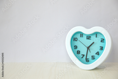 Wallpaper Mural Heart-shaped alarm clock, white frame, blue clock face dial, copy space Torontodigital.ca