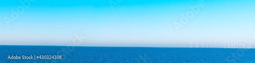 Light blue sky, deep blue sea, wind power energy