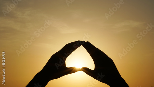 Sunset, sunset in heart shape hands