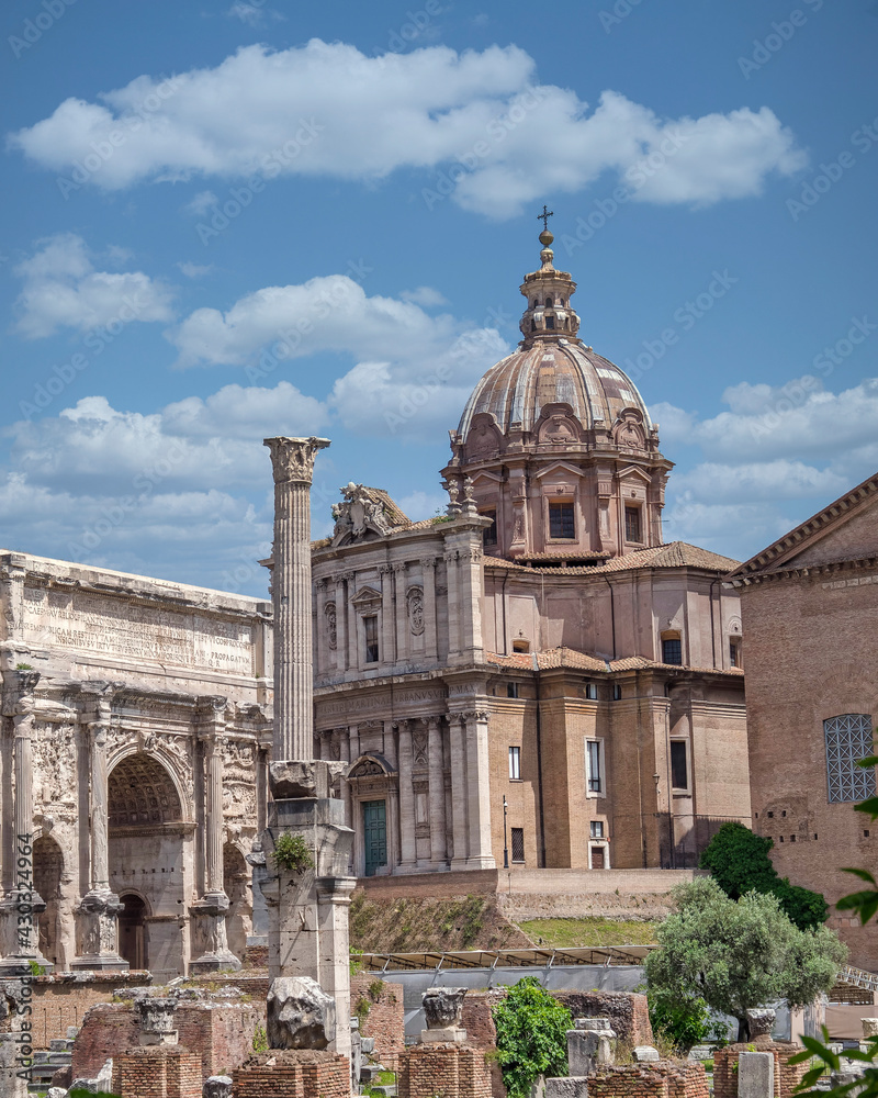 Rome Italy, trionfal arch of Septimus Severus Caesar and Santa Martina church under impressive sky