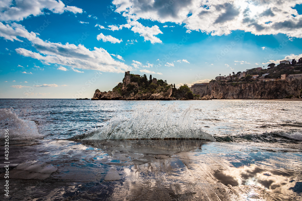 Waves splashing on the shores of Isola Bella beach, Taormina, Sicily 