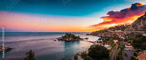 Panoramic view of Isola Bella in Taormina, Sicily  by the warm sunset light  © VanSky