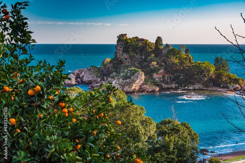 Orange trees and turquoise sea at Isola Bella in Taormina, Sicily  photo