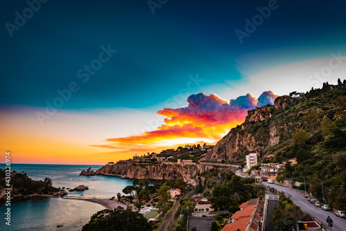 Colorful sunset sky over the bay of Isola Bella- a little island on the Mediterranean coast in Italy  © VanSky