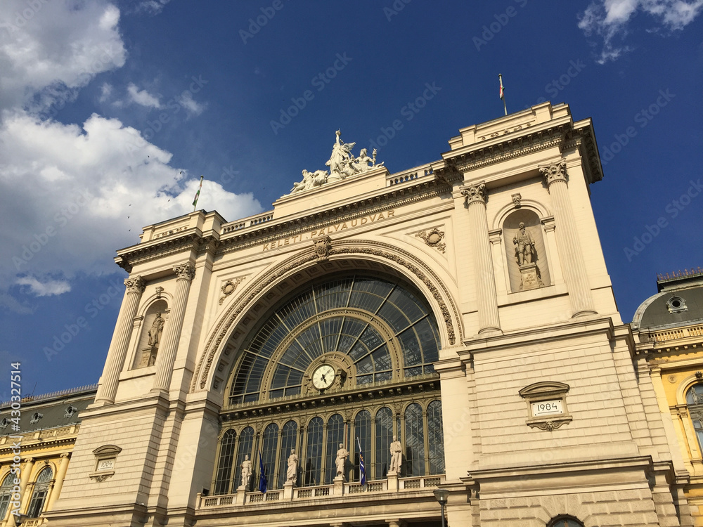 The exterior facade and station clock of the Budapest Keleti railway station (Keleti pályaudvar), the main international and inter-city railway terminal in Budapest, Hungary.