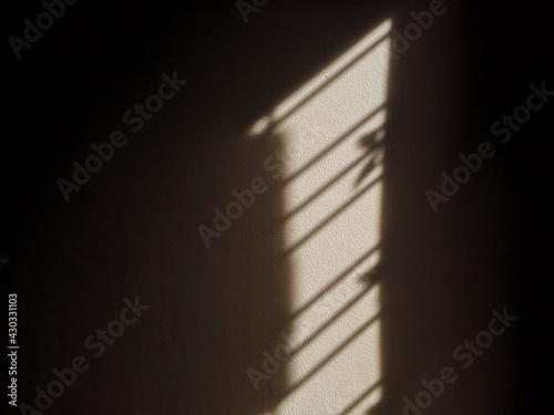 Abstract, light and shadow on dark walls.