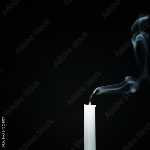 White candles line separating black background that extinguishes religion, faith and peace.