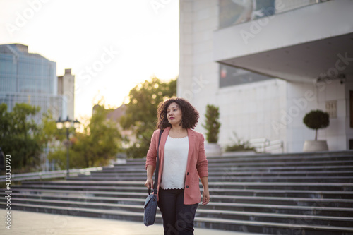 Woman walking on city street.