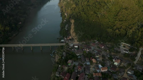 aerial drone shot of the bridge and river of Nong Khiaw , a town in Laos Asia with beautiful high mountains and nature photo