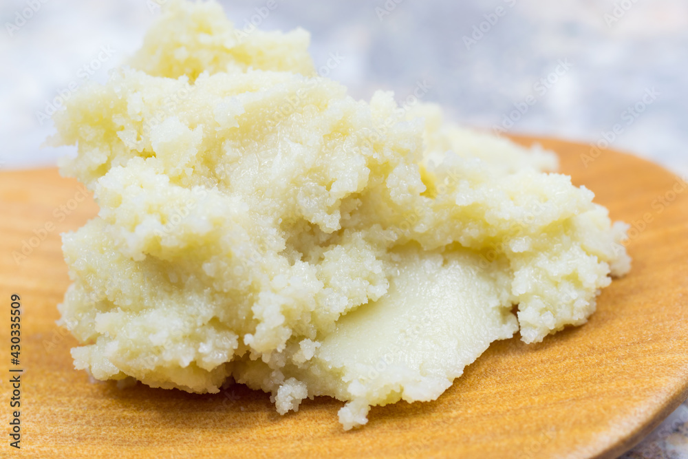 Shea butter on light background, unrefined, close up Shea butter on light background, unrefined, close up
