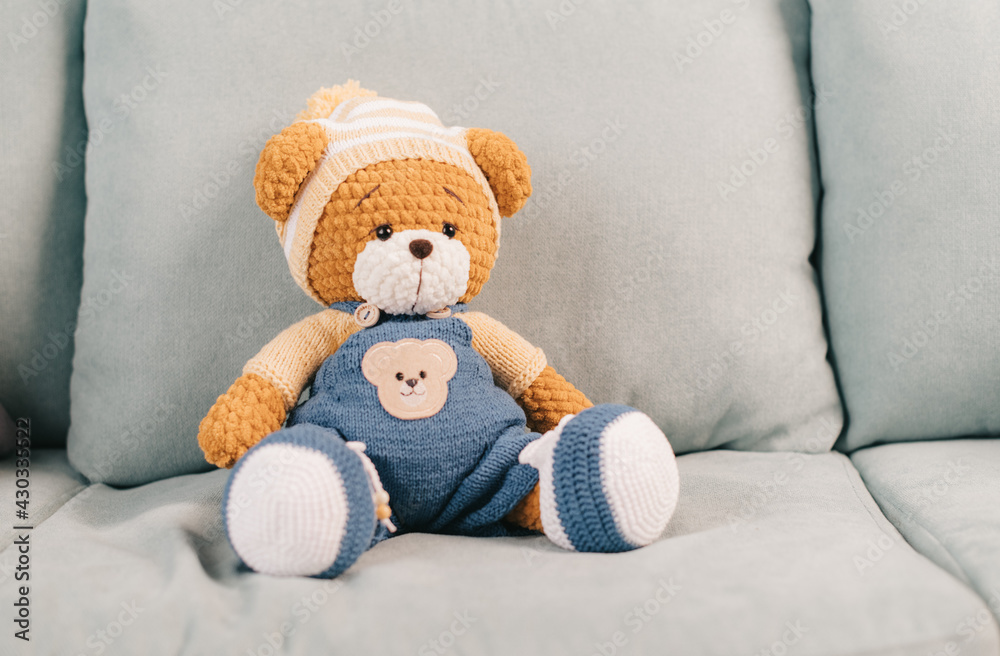 knitted toy bear on the couch