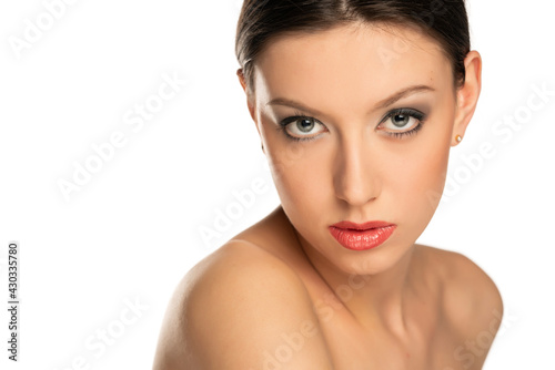 Sensual portrait of a young beautiful shirtless woman with blue eyes and makeup