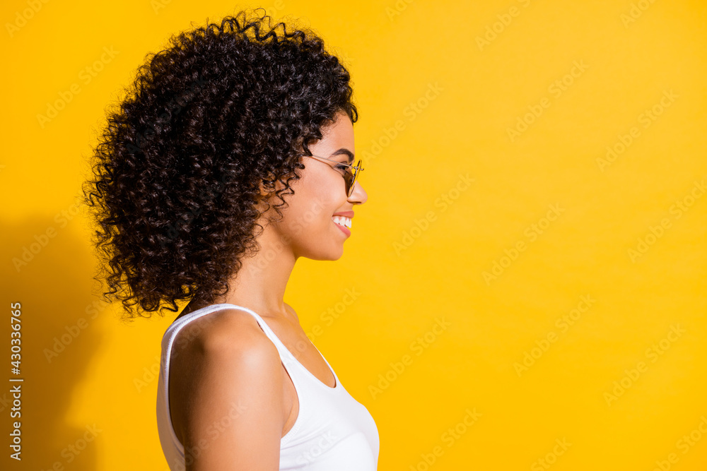 Profile side photo of pretty afro american young woman look copyspace isolated on shine yellow color background Profile side photo of pretty afro american young woman look copyspace isolated on shine yellow color background
