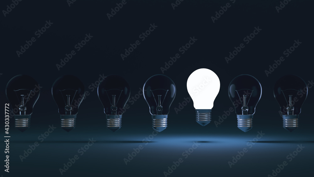 New Idea concept and light bulb that illuminate on blue background. New Idea concept and light bulb that illuminate on blue background.