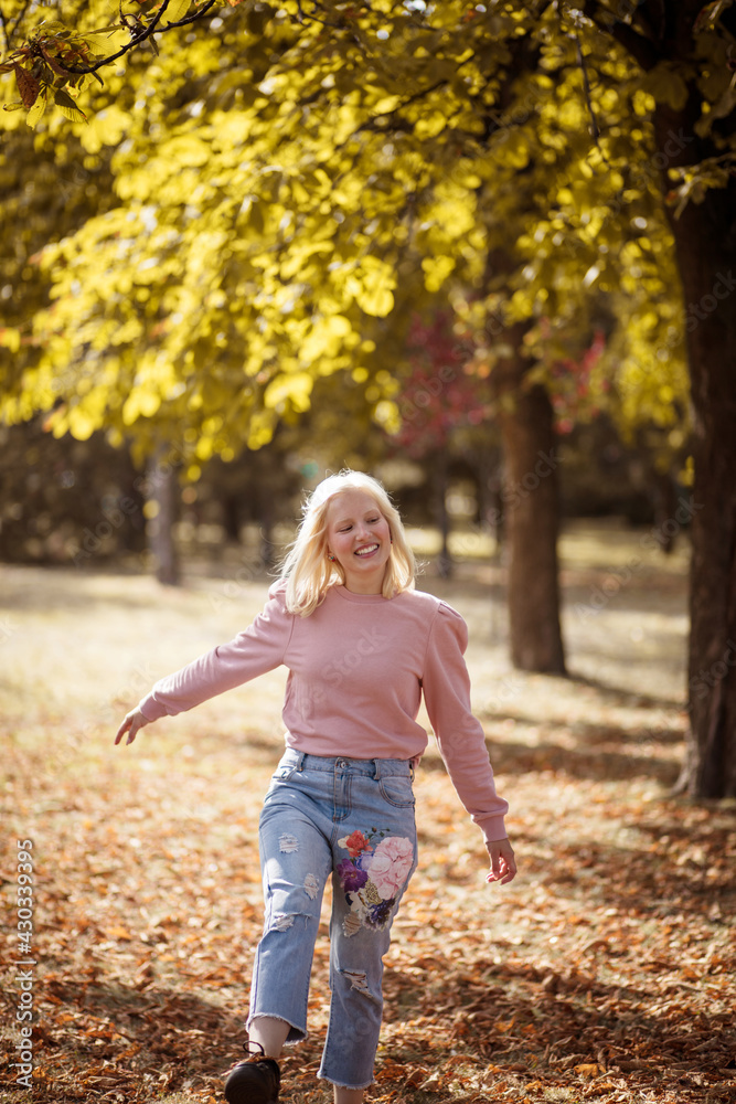 Happy young woman walking trough park. Happy young woman walking trough park.