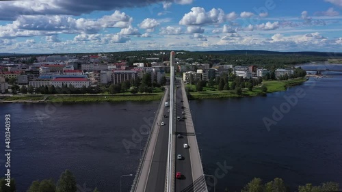 Aerial view over traffic on Bridge, revealing downtown Rovaniemi - circling, drone shot photo