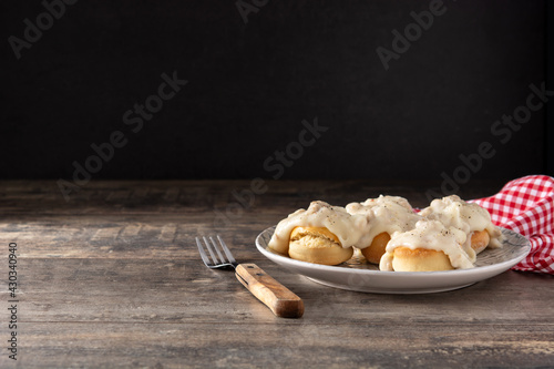 Slika na platnu Traditional American biscuits and gravy for breakfast on wooden table