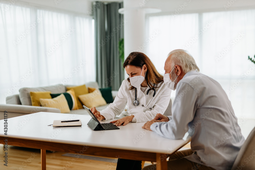 Patient and female doctor, wearing face masks.