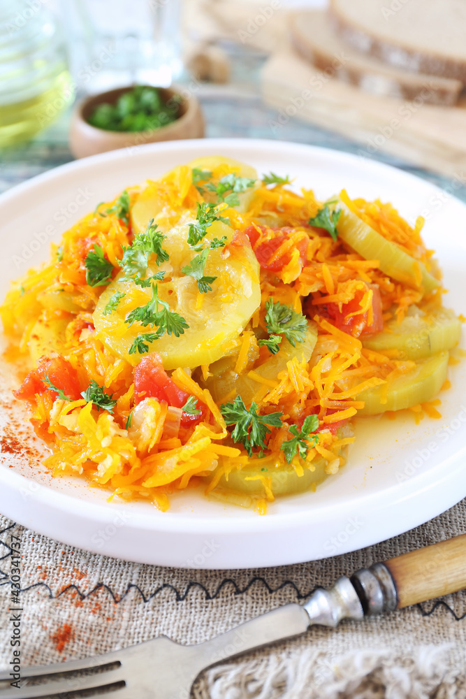 Vegetable dish. Stewed zucchini with carrots and tomatoes, dressing parsley Vegetable dish. Stewed zucchini with carrots and tomatoes, dressing parsley