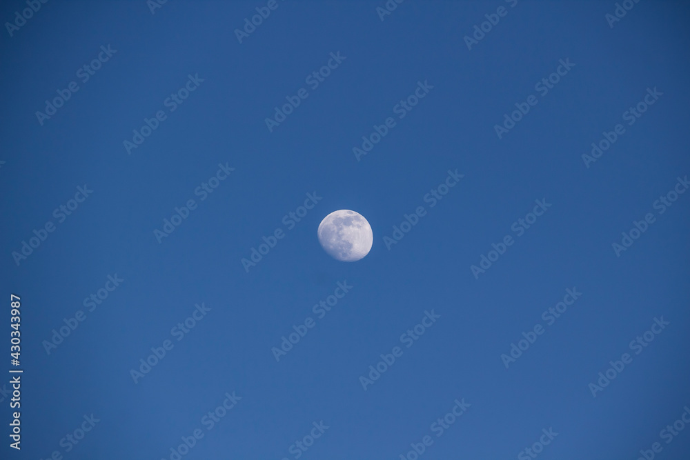 A beautiful moon in the blue sky against background A beautiful moon in the blue sky against background