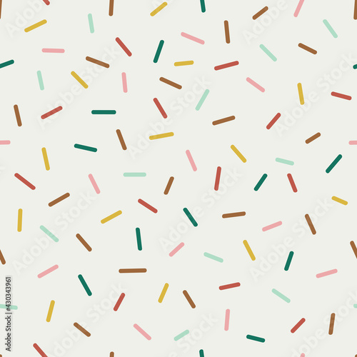 Seamless vector pattern with decorative sprinkles. Colourful donut glaze or ice cream top festal background. Celebrating Christmas party dash confetti backdrop.