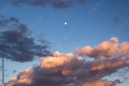 A beautiful dark clouds in the blue sky with moon against background