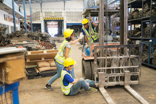 Accident of working man in extreme wide shot, forklift over leg of engineer. Asian engineer worker man was crushed by a forklift and engineer woman told driver stop it in factory-warehouse