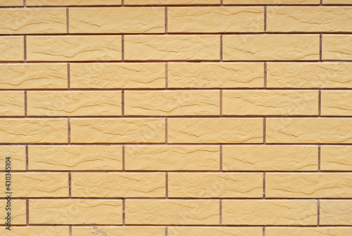 Texture of brick wall. Samples of wall or fence are presented at exhibitions. Yellow brick close up.