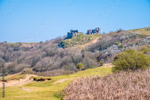 A view from Three Cliffs Bay towards the ruins of Pennard Castle, Gower Peninsula, Swansea, South Wales on a sunny day photo