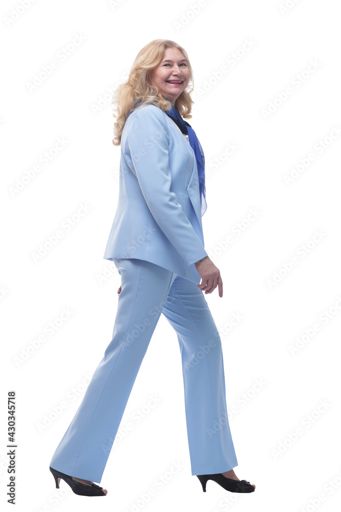 side view. confident woman in a pantsuit striding forward. side view. confident woman in a pantsuit striding forward.