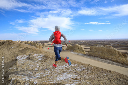 Woman trail runner cross country running on sand desert dunes