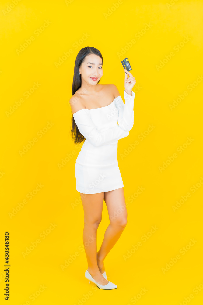 Portrait beautiful young business asian woman with smart mobile phone and credit card Portrait beautiful young business asian woman with smart mobile phone and credit card