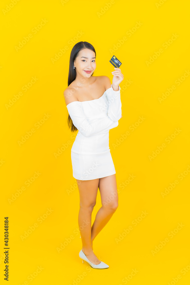 Portrait beautiful young business asian woman with smart mobile phone and credit card Portrait beautiful young business asian woman with smart mobile phone and credit card