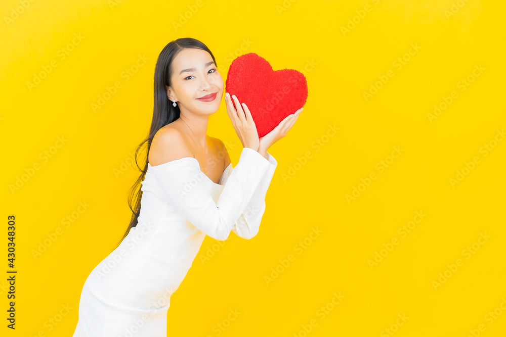 Portrait beautiful young business asian woman with heart pillow shape
