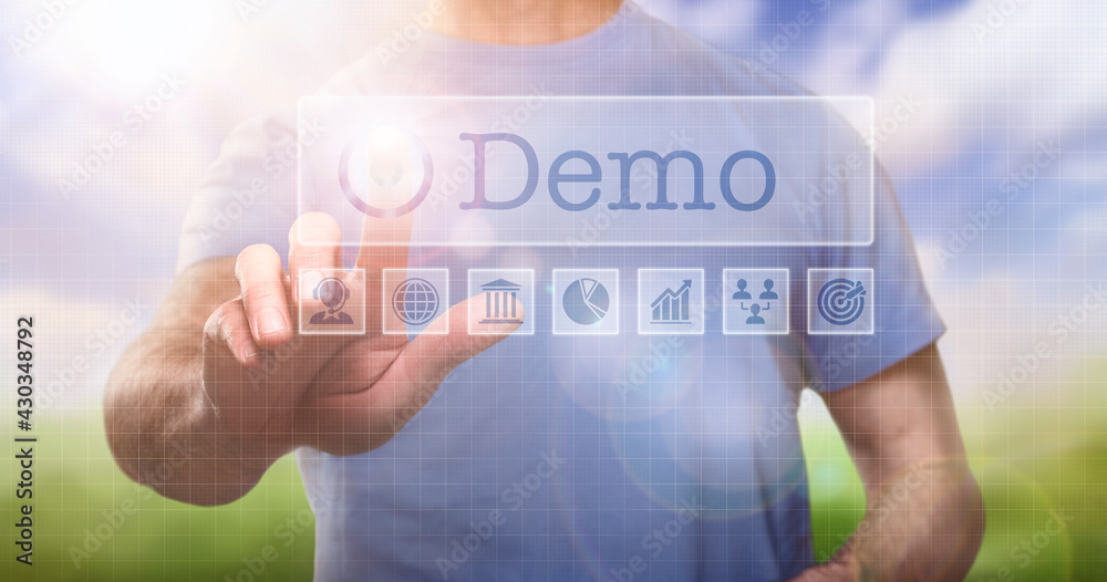 A man in a t-shirt outside selecting a Demo word concept on a computerised display