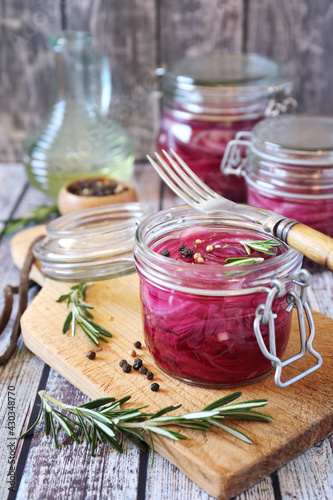 Pickled red onion salad in jars, spices and rosemary