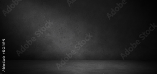 Fototapeta Naklejka Na Ścianę i Meble -  Dark concrete wall and floor texture background with lighting, Neutral three dimensional room in the dark  for mock up or product display	
