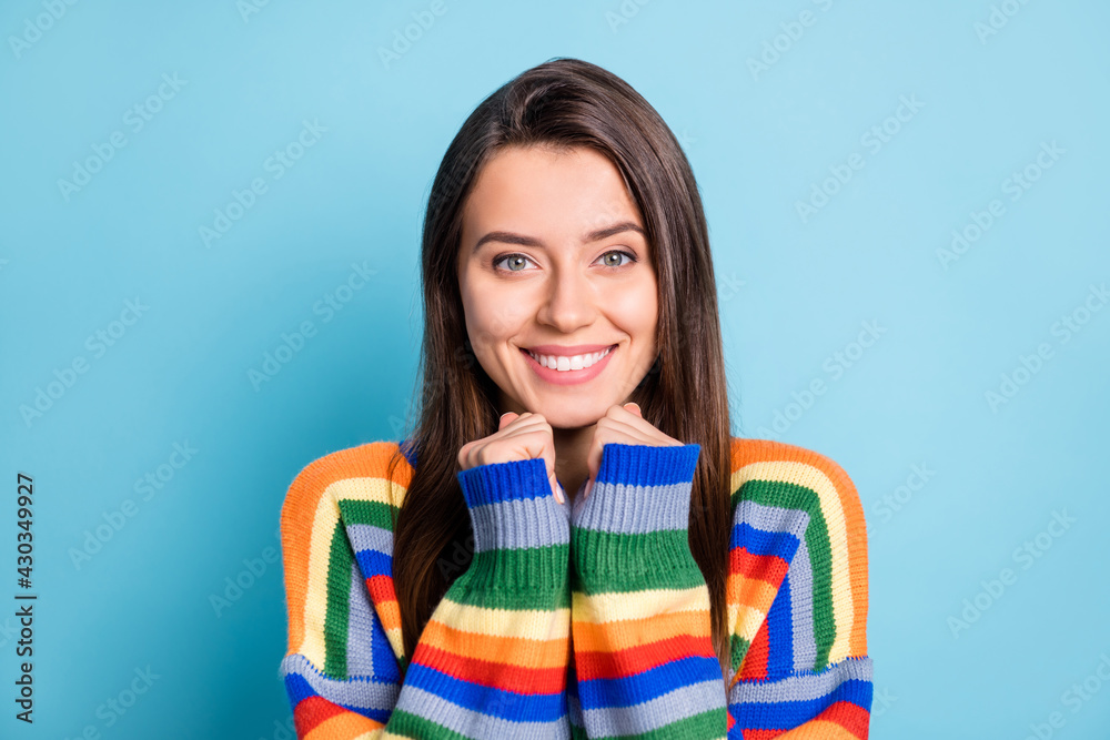 Portrait of attractive cheerful brown-haired girl enjoying good mood isolated over bright blue color background