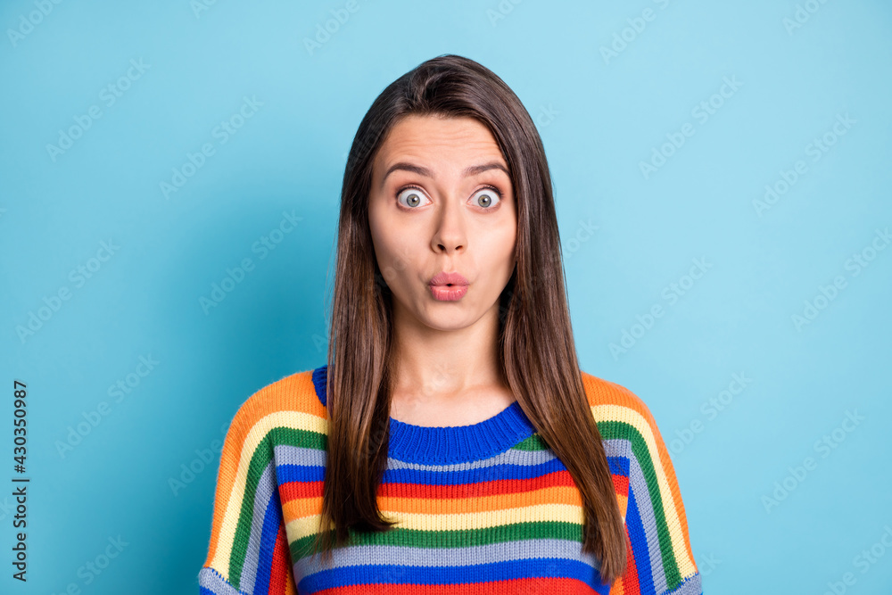 Photo portrait of shocked woman whistling in striped outfit staring isolated on vibrant blue color background Photo portrait of shocked woman whistling in striped outfit staring isolated on vibrant blue color background