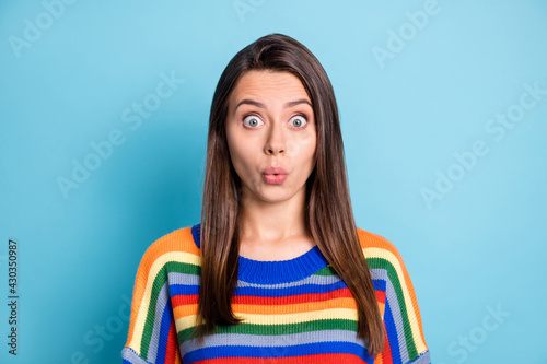 Photo portrait of shocked woman whistling in striped outfit staring isolated on vibrant blue color background