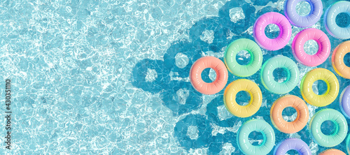 swimming pool seen from above with many rings floating photo