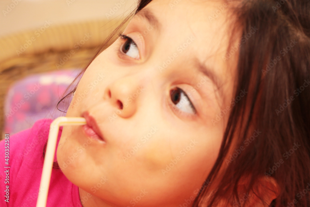 Little girl drinks milk for breakfast in kindergarten. Healthy baby food. Little girl drinks milk for breakfast in kindergarten. Healthy baby food.
