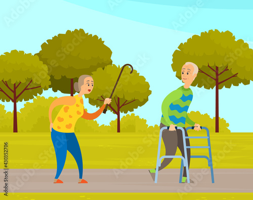 Old people man and woman on walk in city garden. Elderly couple with walking cane and walker in park. Grandparents walking outdoors together enjoying good warm weather along an alley with green trees