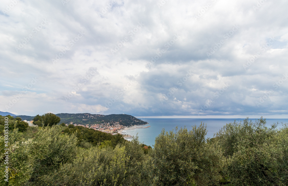 italian landscape with hill view mediterranean sea, nature, houses and clouds on sea in cloudy day